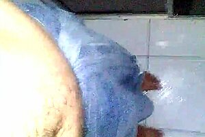 Young man masturbates standing in the bath
