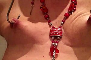 She stretches her tits in bdsm play