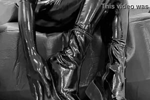 She struts in HIGH HEELS and LATEX GLOVES, teasing with shiny leggings.