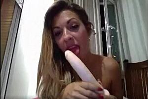 Naomi deepthroats dildo on webcam.