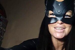 Brunette mistress in latex dominates slave with femdom bdsm close-up