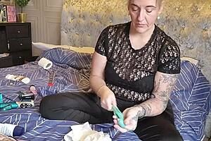 The mature wife explores her collection of sex toys in a homemade session