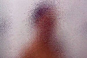 In the shared hostel bathroom, redhead gives handjob during shower