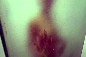 In the shared hostel bathroom, redhead gives handjob during shower