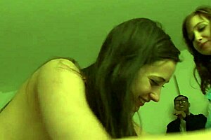 brunette women kiss on the sofa before using toys