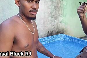 A couple enjoys oral sex by the pool.