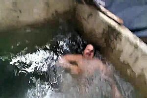 Two man attempt to get their muff diving at the neighbors fish tank