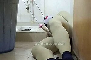 zentai slave bound in penis toilet bondage