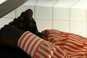 Black gay guy at public urinal stroking cock while spying.