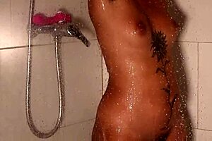 A person is bathing in the shower, enjoying the warm water flowing over their body.