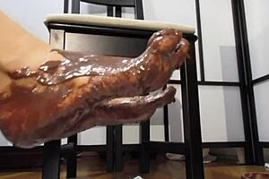 Feet Covered in Chocolate Cream