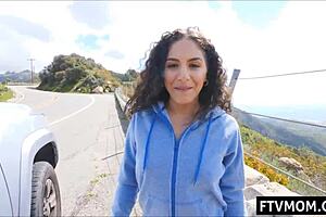 latina milf flashing tits and ass in public outdoor scene.