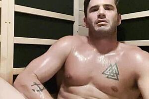 Sexy man getting down to business during a solo session in the sauna