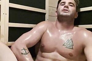Sexy man getting down to business during a solo session in the sauna