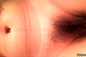 Asian babe with huge tits masturbates in the bathroom.