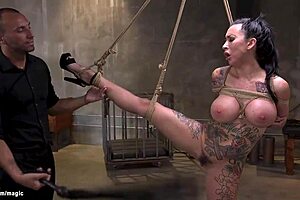 Tattooed squirter with huge tits bound and tormented.