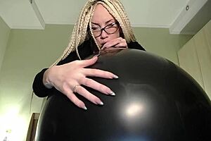 Tattooed Slut gets a huge balloon and pierces the balloon with her nails