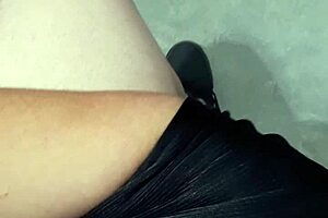 A woman flashes at the laundry mat, surprising a mature lady who looks intrigued.