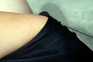 A woman flashes at the laundry mat, surprising a mature lady who looks intrigued.