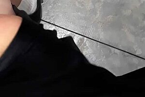 A woman flashes at the laundry mat, surprising a mature lady who looks intrigued.