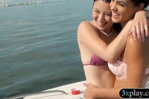 Two slutty girls in bikinis having foursome fun on a speedboat