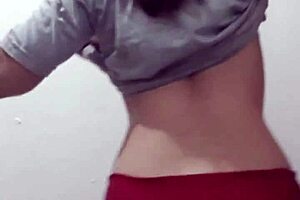 Young woman exposes her chest and strains herself to capture the scene