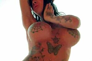 Shaking big tits while dancing naked in a steamy sauna