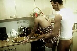 A blonde woman assists herself and her partner to have a cream bath in the kitchen and them have oral sex and the doggystyle intercourse before he ejaculates
