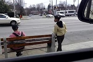 Slender beauty at bus stop public display