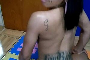 brunette tattooed girl sits on the console topless for the first time in a sensual way