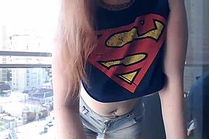 Foxy Red-head Exposes Huge Boobs To The World While On A Balcony