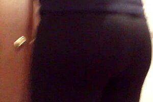 Cross gay trying on leggings in a provocative way