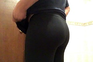 Cross gay trying on leggings in a provocative way