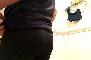 Cross gay trying on leggings in a provocative way