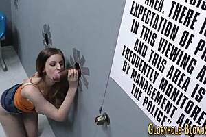 This interracial babe takes a very thick black cock through a glory hole