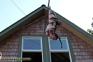 ballgagged slave dangling in bondage