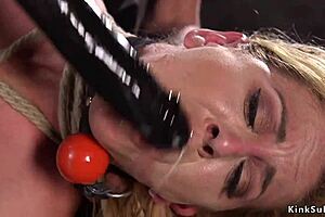 Submissive woman is nipple clamped and hogtied