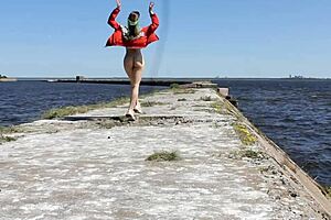 Naked Woman Poses Outdoors On Public Dock In Reality Video