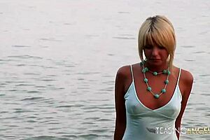 Blonde teases on beach, gets wet, rips clothes, exposes shaved pussy