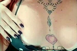 tattooed redhead shows tan lines on big tits and ass