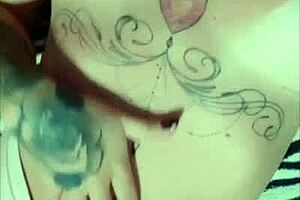 tattooed redhead shows tan lines on big tits and ass