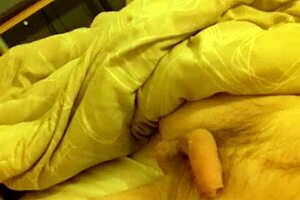 In the bedroom, he wanks his long thin cock to a massive cumshot