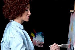 Ryan Keely gets wet during painting with the art of Bob Ross