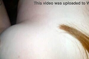 Beautiful Brazilian redhead housewife in homemade living room sofa scene