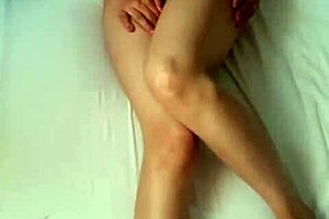 A small girl with attractive shaped fusiform figure satisfies herself with fingers and gets physical arousal