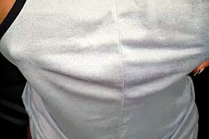 Up close, a black woman has stunning breasts that entice you