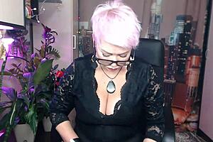 Sexy, blonde, MILF dances provocatively, pleasuring herself in fishnets
