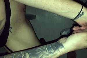 Tattoed chick sucks stranger in video booth.