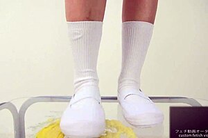 The girl says, 'watch me crush this banana with my feet.'