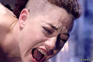 Redhead slave whipped and fingered in bondage